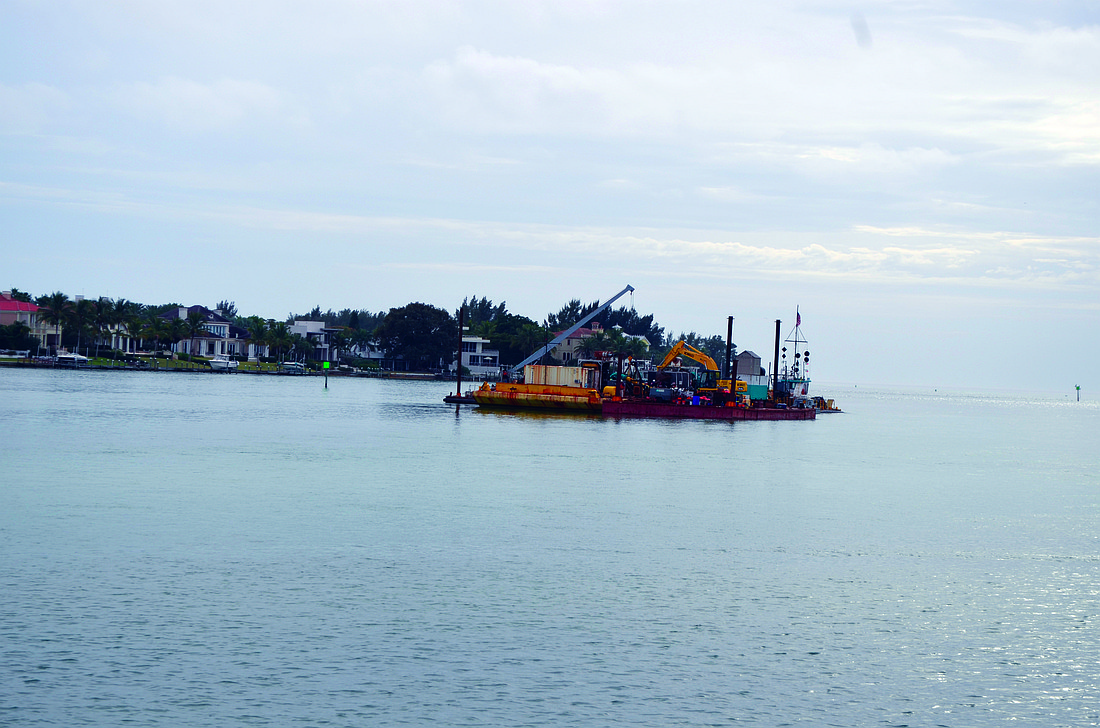 Through March, dredging crews will take sand from New Pass to restore sand lost from the Lido Key shoreline following Tropical Storm Debby. Photo by Robin Hartill