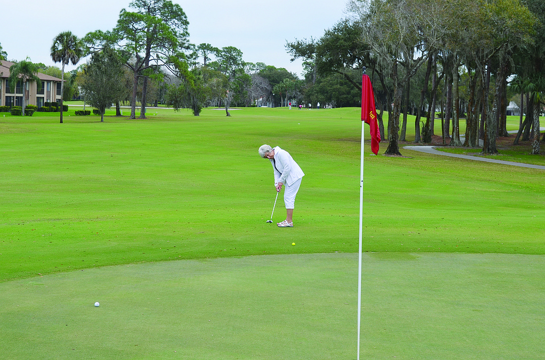 Shirley Kelley of Sarasota hits a putt that approaches the green Tuesday at The Palm-Aire Country Club. Photo by Jason Clary