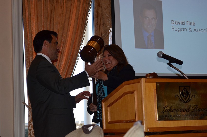 Alliance Chairman David Fink accepts the gavel and leadership position from former Chairwoman Annette Gueli.