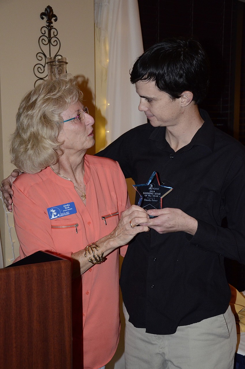 Aledia Tush gives Timothy Palmer the Shining Star Award.