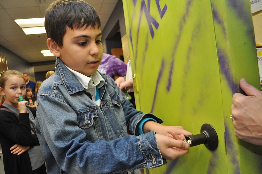 Elvin Karimov, 9, unlocks a door to win a prize.