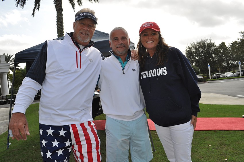 Mike and Katie Emmons pose with event sponsor Fernando Pires, center.