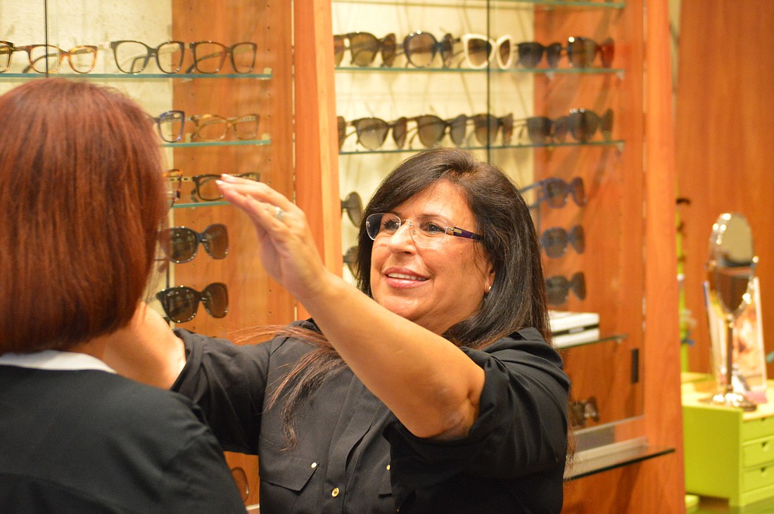 Yvonne Schloss, pictured in September 2014, helps customers at her business, Sunglass Optical Express, on St. Armands Circle. Schloss' role with the chamber was a 100% volunteer role. File photo