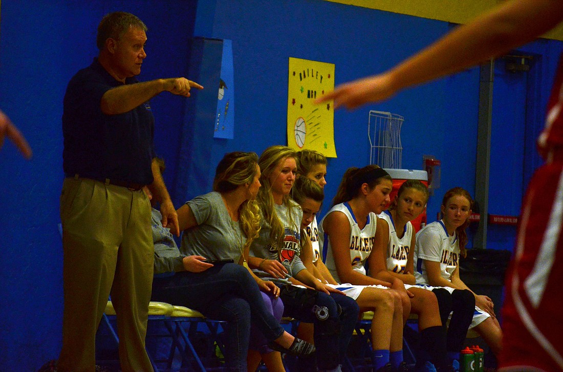 Sarasota Christian coach Scott Lantz, left, and daughter McKenzie Lantz, second from left, on the sidelines during an SCS girls basketball game against Palmetto Jan. 22.
