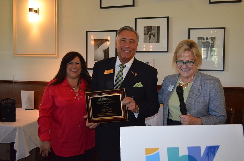 Andrew Vac, of RE/MAX, with 2014 Chairman of the Board Yvonne Schloss and President Gail Loefgren, accepts his Chairmanâ€™s Award.