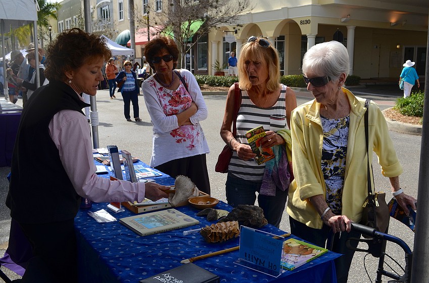 Brynne Anne Besio, of the South Florida Museum, talks fossils with Caroll Nisbet and Veronica Carter.