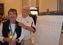 Seahawks Fan Karen Sawyer and Patriots fan Paul Kuell place their bets.