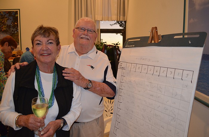 Seahawks Fan Karen Sawyer and Patriots fan Paul Kuell place their bets.