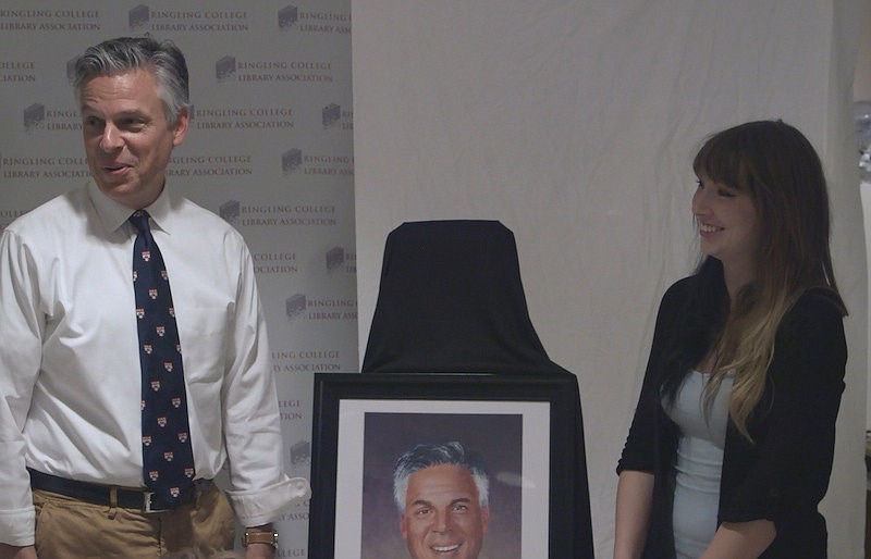Former Utah Gov. Jon Huntsman Jr. accepts a painting from Ringling College of Art and Design senior Cameron Kramer during a visit to Sarasota Monday.
