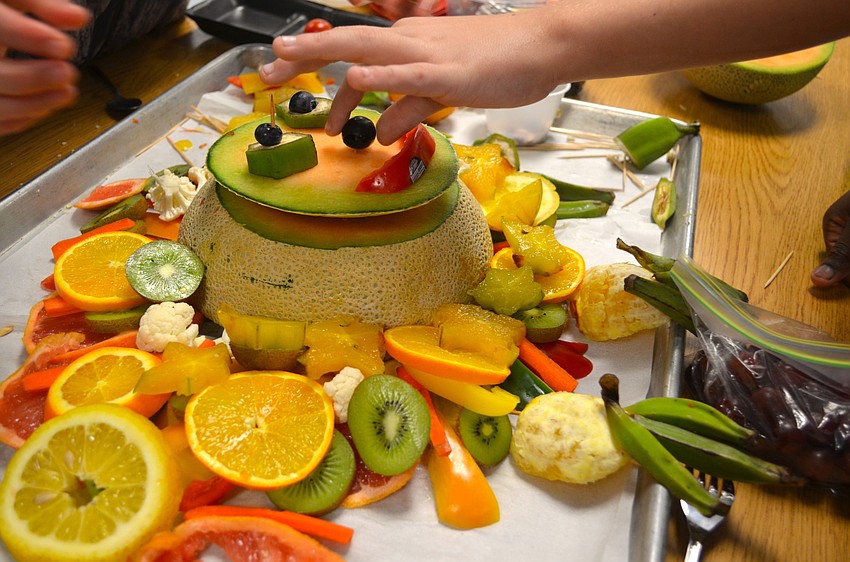 Students crafted lions, elephants and other animals out of fruit and vegetables.