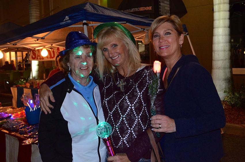 Martha Walker, Lynn Pelton and Jan Walker show off their new glowing toys.
