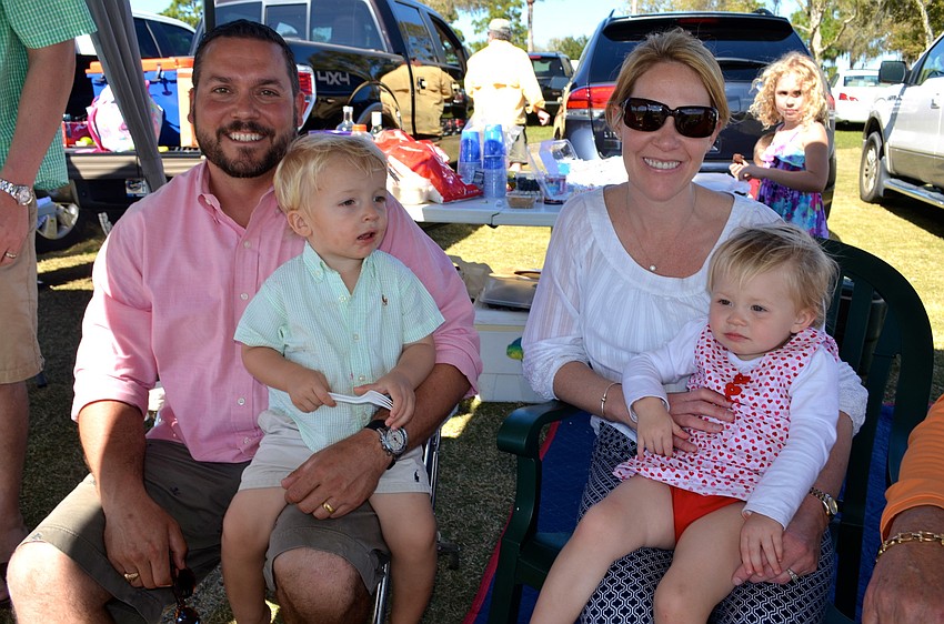 Doug Grosso and his son, Daniel, relax and watch the match with friends, Sarah and Kelsey Lodge.