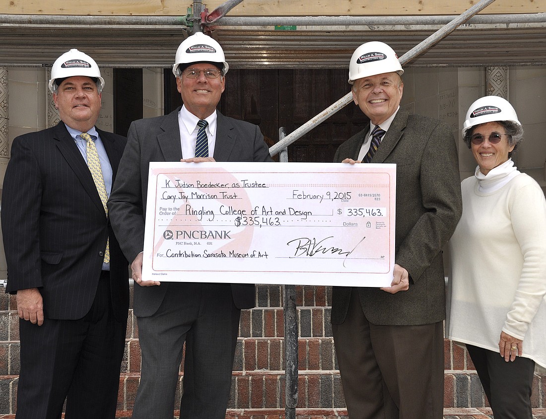 Brad Goddard, K. Judson Boedecker, Larry R. Thompson and Wendy Surkis displaying the check in front of the under construction Sarasota Museum of Art.