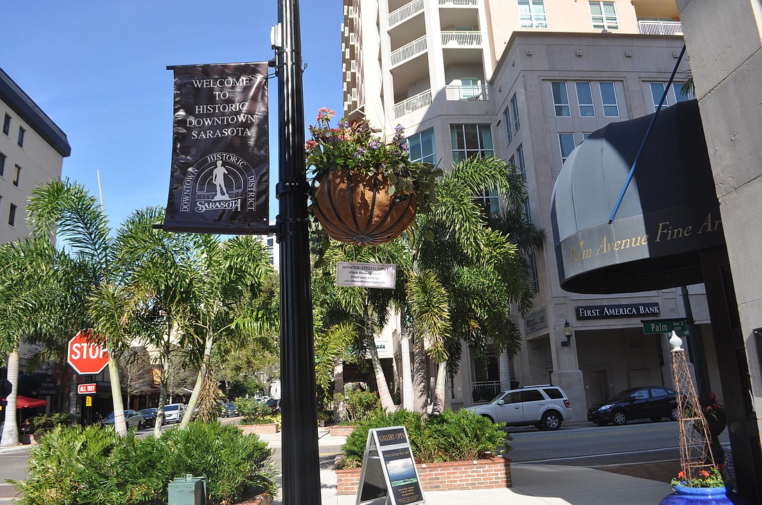 One of three demo flower baskets located at Main Street and Palm Avenue, the first option offered by the Downtown Improvement District features a hanging basket off the arm of a light pole.