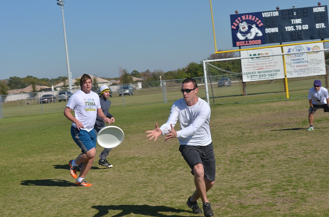 Chris Eaton catches a Frisbee. Photos by Jason Clary