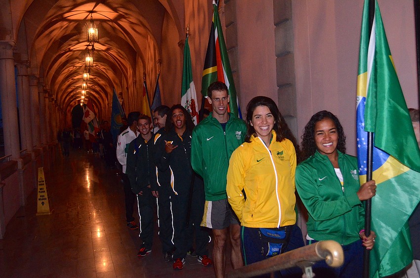 Athletes from 35 countries show off their countries' flags.