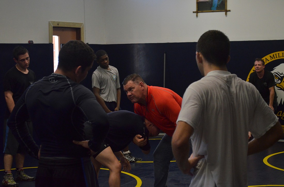 SMA assistant coach Kevin Jakub demonstrates a technique on Robert Herrera. Photos by Jason Clary