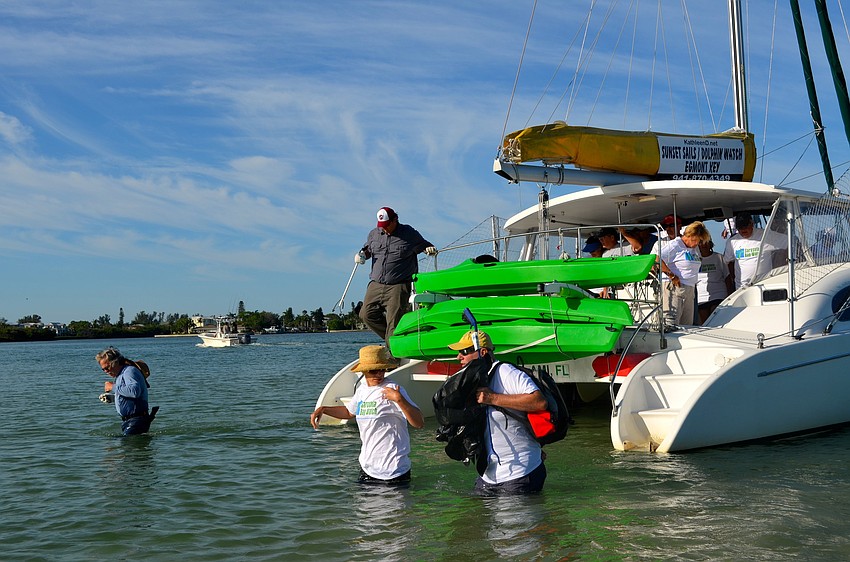 Volunteers must leave the catamaran a few yards out and wade through shallow water to get to the islands.