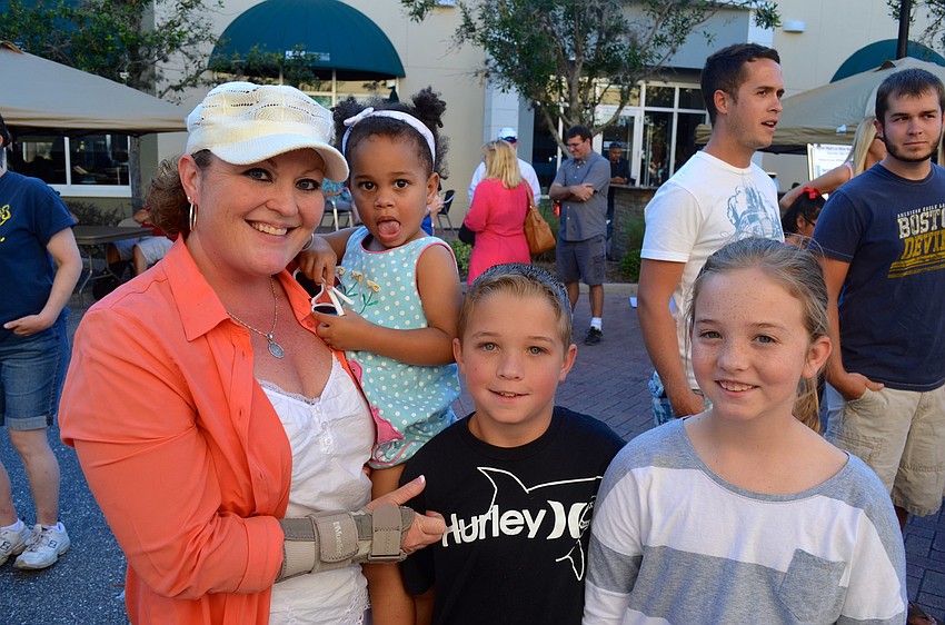 Brandy Conway holds Sarah Thompson, while posing with Aaron and Caitlynne Conway.
