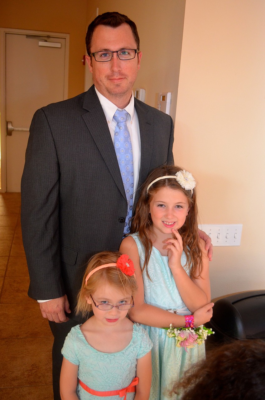 Matt Miles stands with his daughters, Makayla and Madalyn.