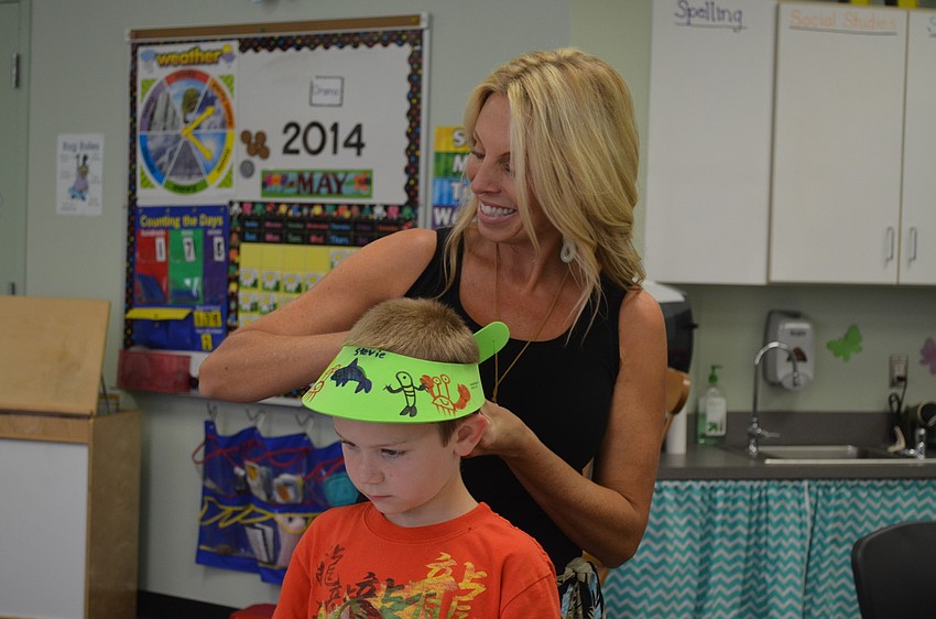 Amy Pedler helps Stevie Roberts with his visor.