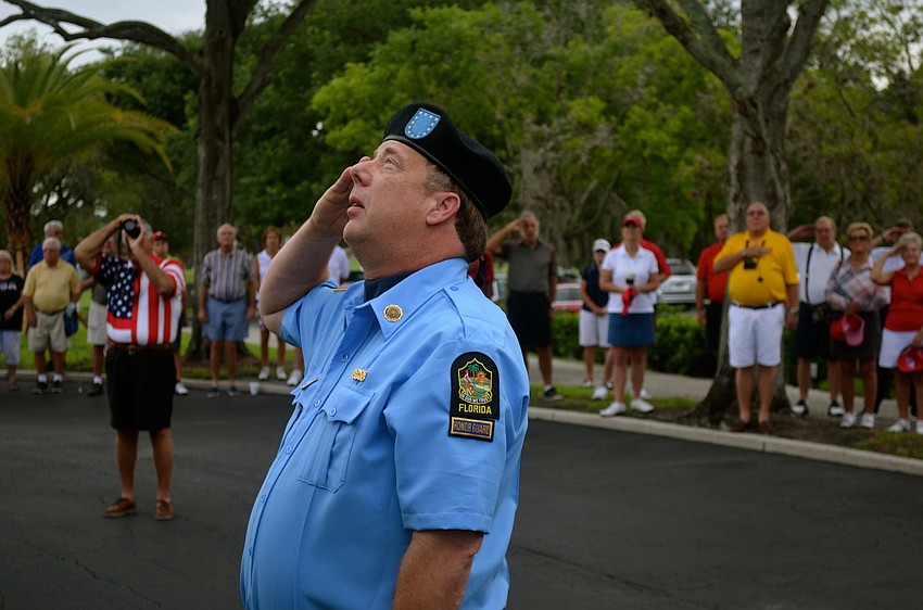 Past Commander of Disabled American Veterans Chapter 18 John Raber salutes the American flag.