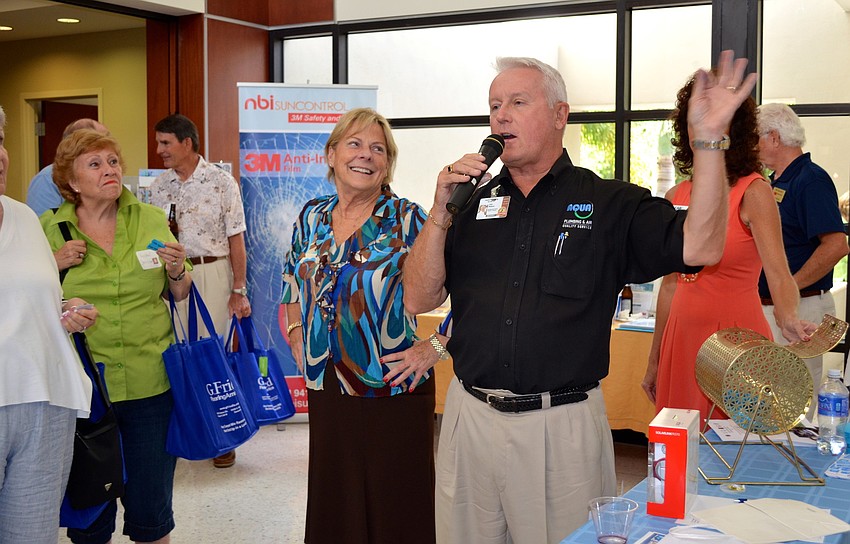 John Wojtyna draws the winning raffle ticket at the end of the seminar.