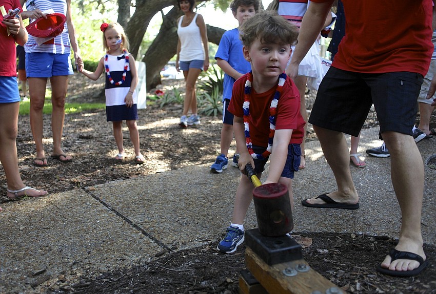 Josh Karasick, 3, plays an old-fashioned game in Bicentennial Park.