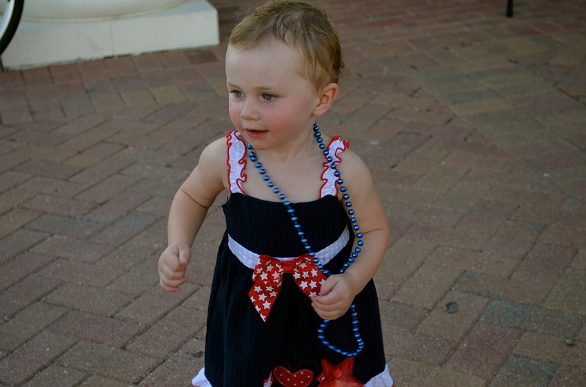 One-year-old Raelyn Dine dances to the music.