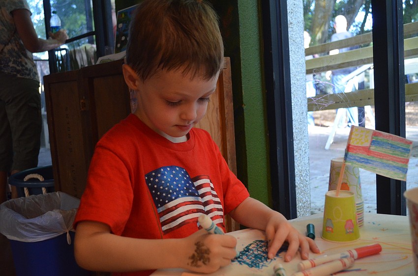 Luke LaFrance draws and American flag.