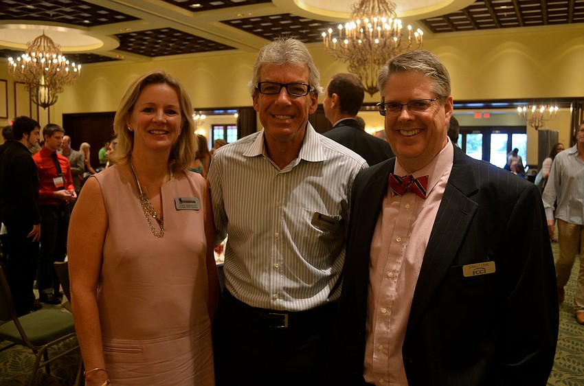 Sheri and Dennis Hernreich socialize with Stanley Eding.