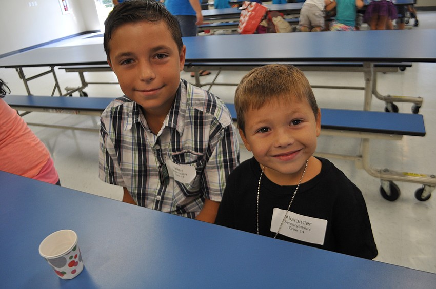 Valeriy an Alexander Serebryanskiy eat snacks together.