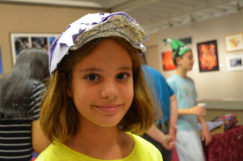Josie Leiderman puts on one of her many caps â€” this one made of tin foil.