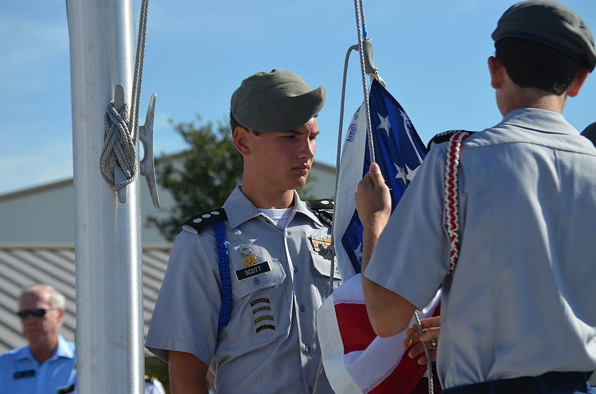 Houston Scott helps raise the flag.