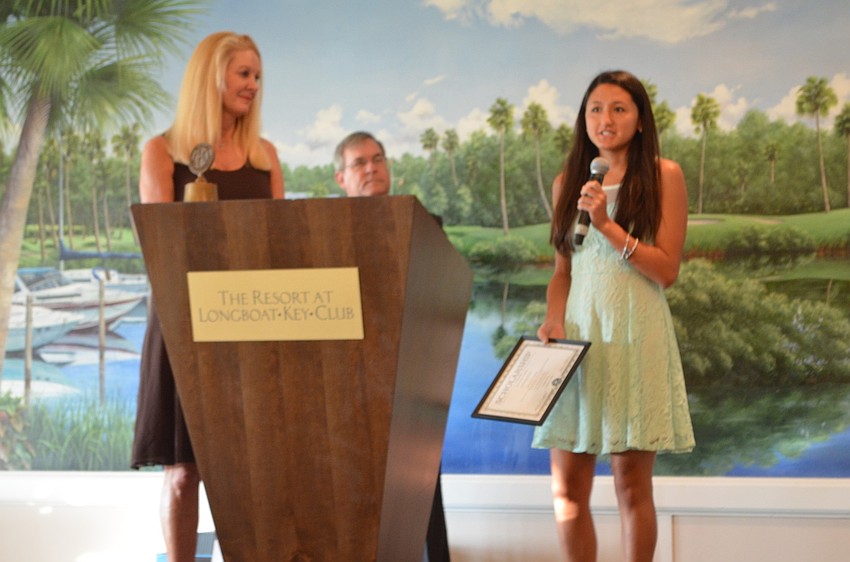 Aina Castelluccio, State College of Florida, is awarded a technical scholarship by Scholarship Committee Chair Susan Philips and Longboat Kiwanis Club President Richard Crawford.