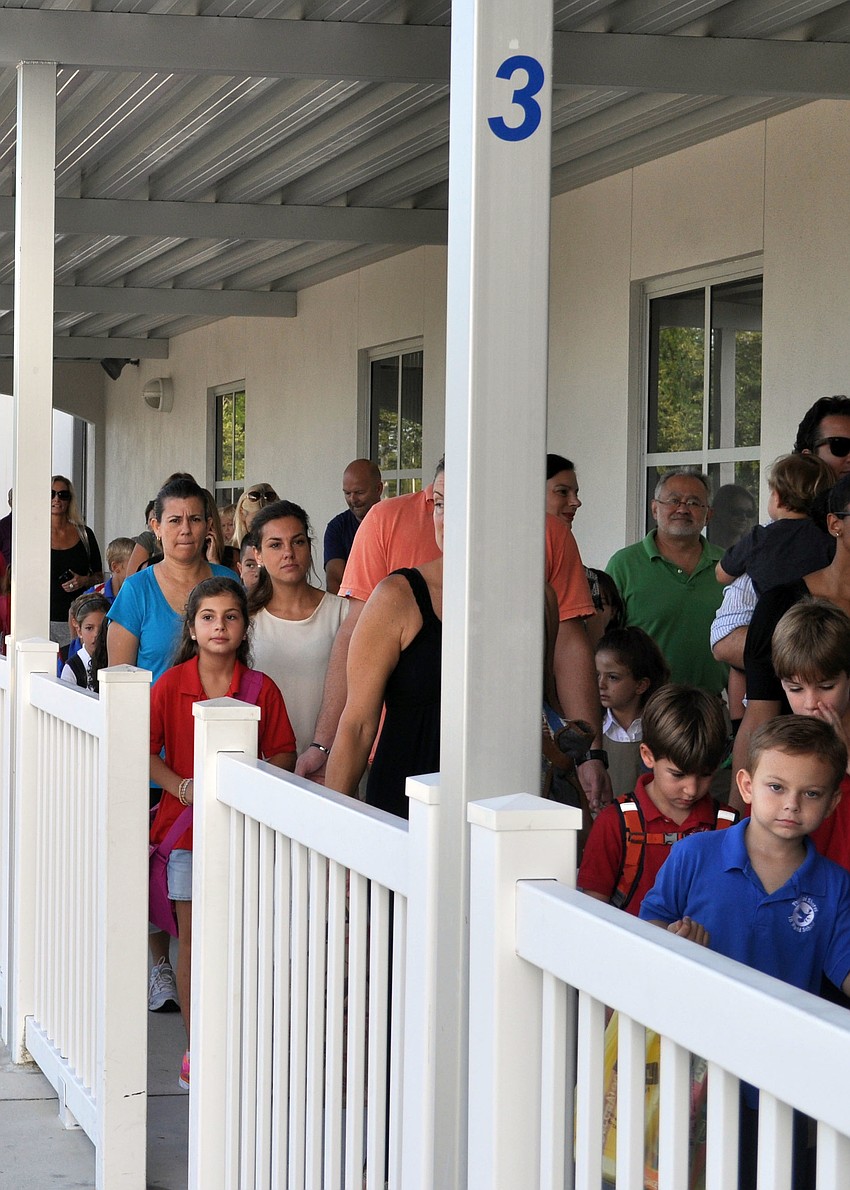Students and parents lined up to enter the building on the first day of school.