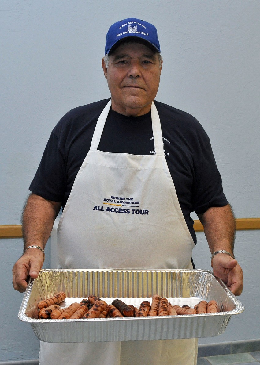Joe Zanpino serves up the first batch of grilled hot dogs.