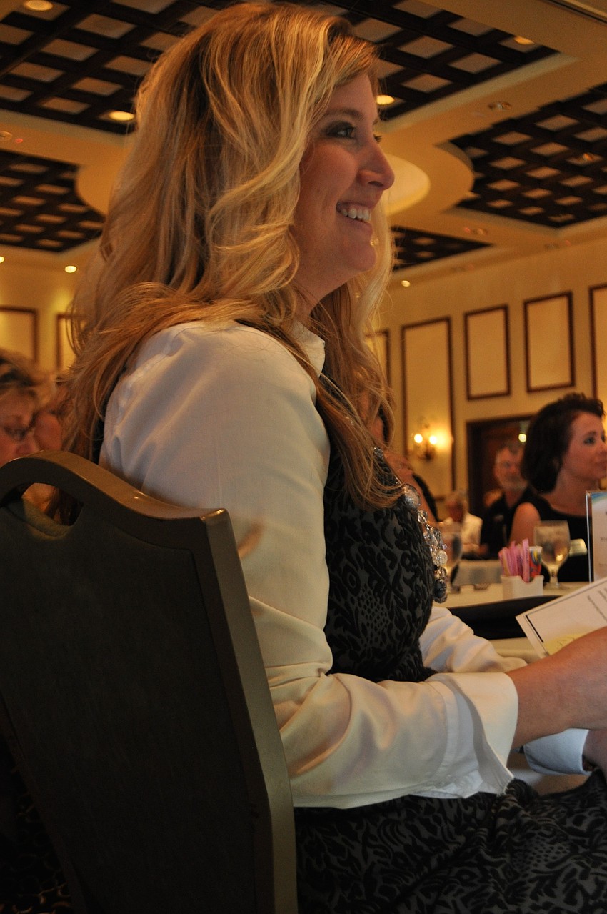 Lakewood Ranch Business Alliance Executive Director Heather Kasten claps as Pat Williams takes the spotlight.