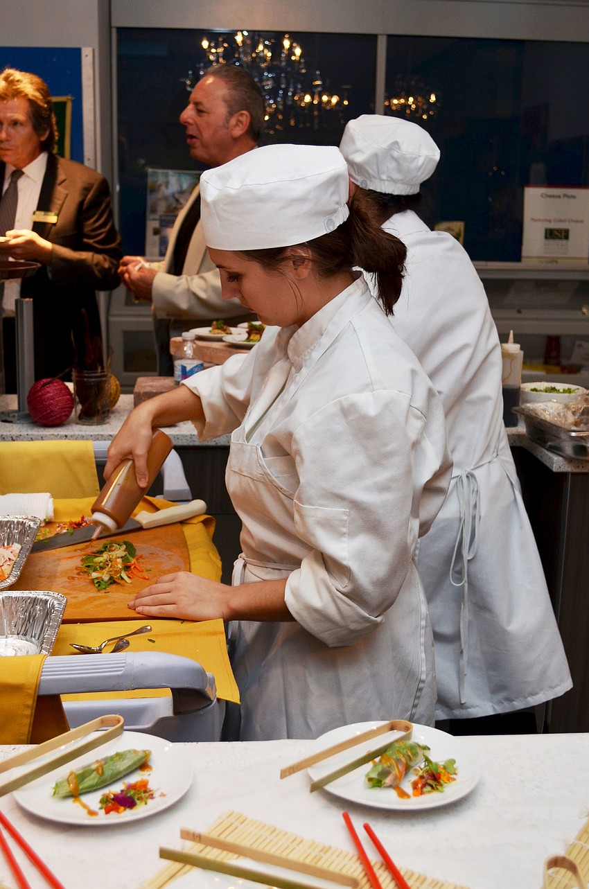 Nicole Juliano prepares vegetable spring rolls with ginger sauce during the Maison Blanche Farm to Fork dinner.