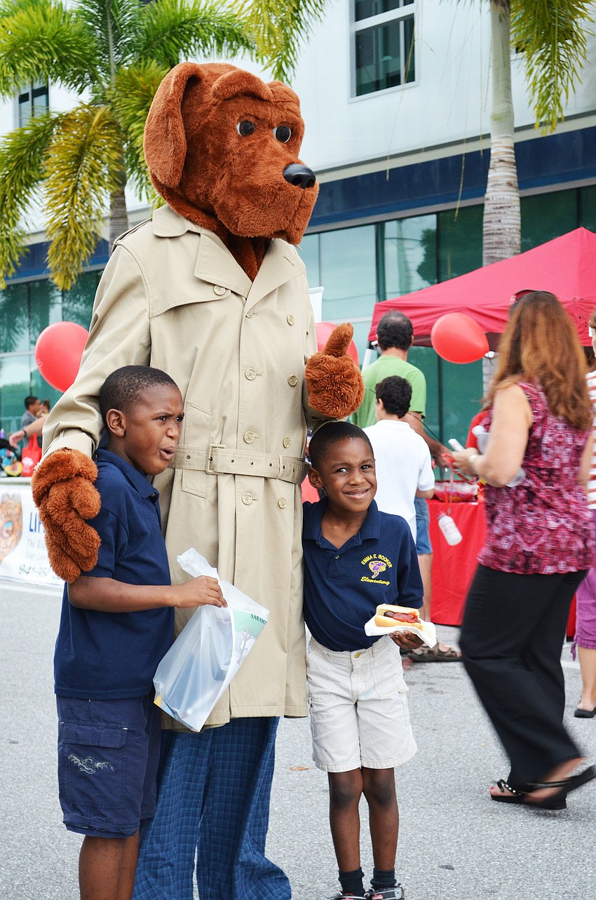 Brothers Lavonde and London Upshaw pose for a photo with Scruff McGruff.