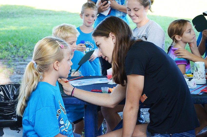 Charlotte Uhee has her face painted at the Phillippi Shores 7K Run.
