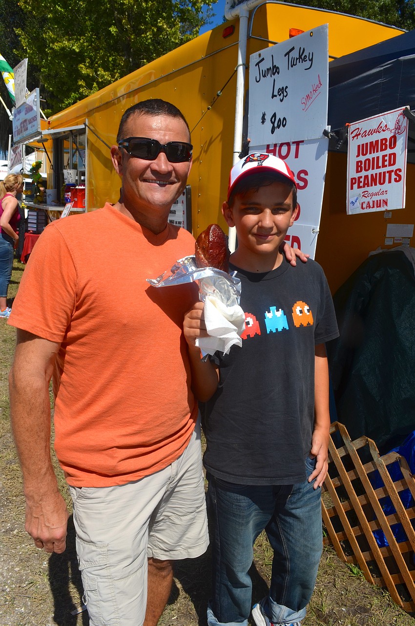 Riess Pellegrino and Colin Gentile snack on a turkey leg.