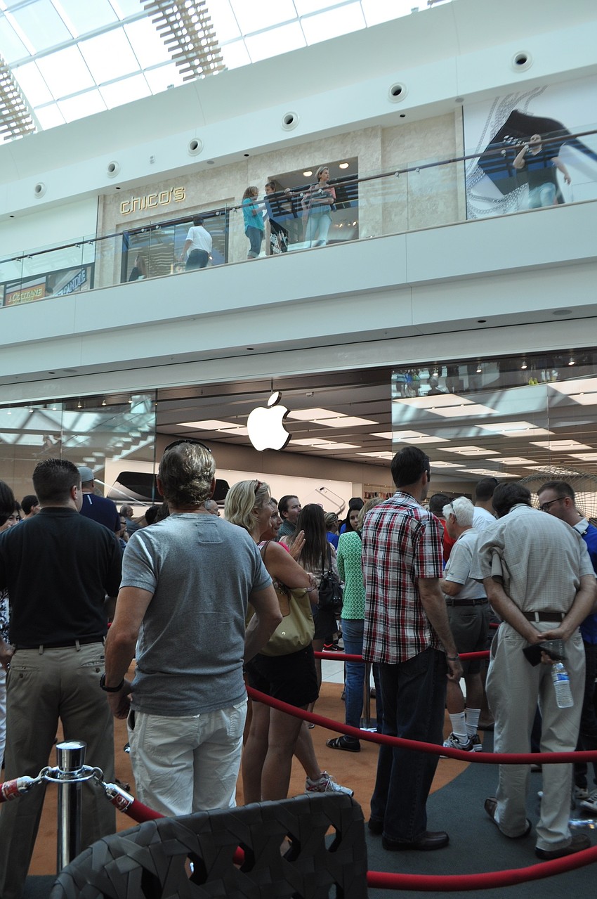 Crowds line up outside the Apple store.