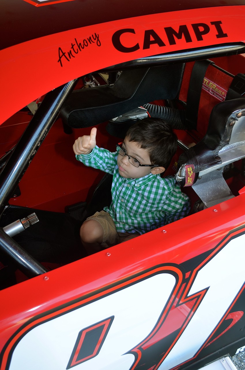 Ethan Ames is impressed with the inside of the race car.