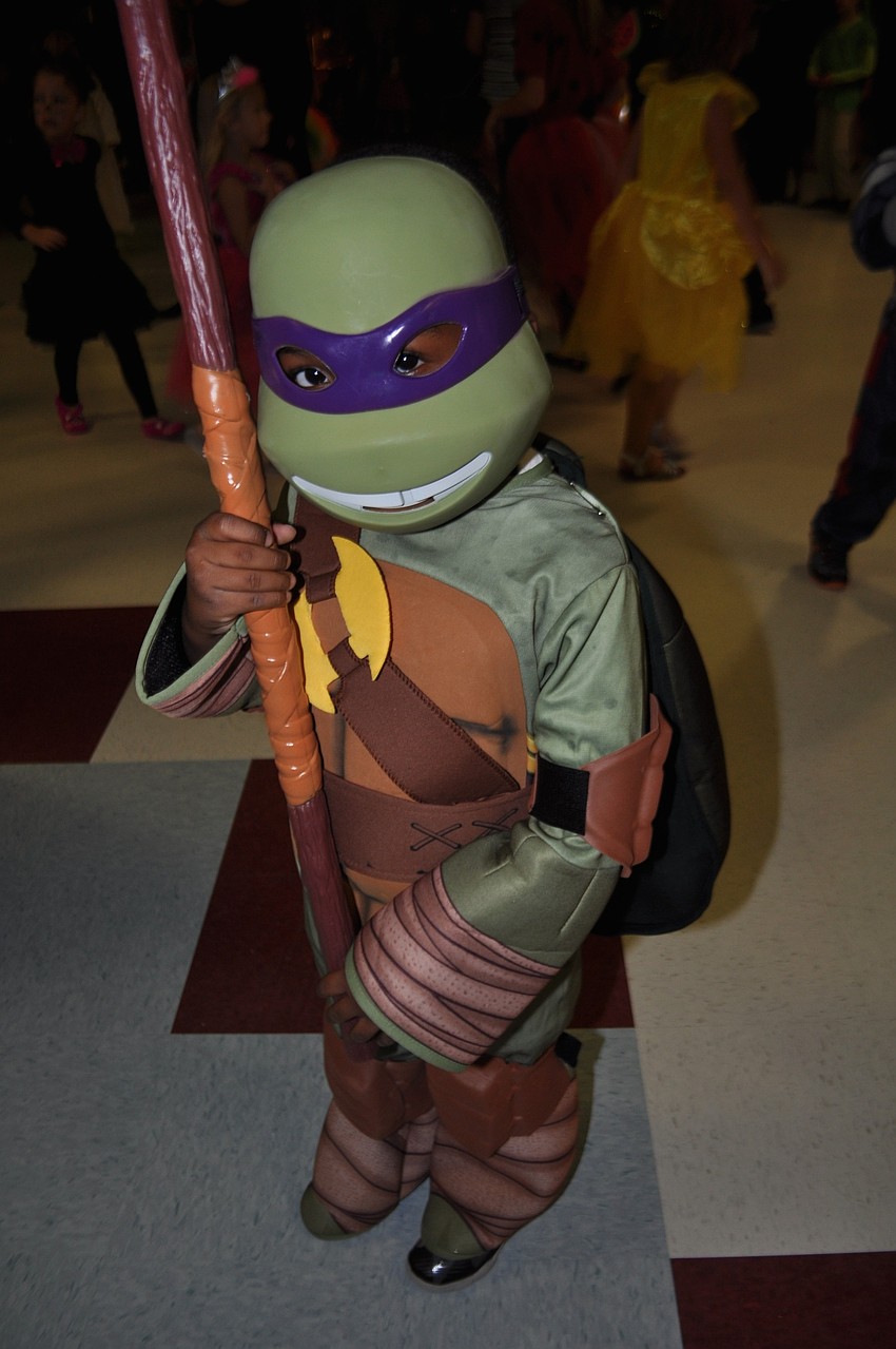 Four-year-old Tony Earl Jr. attends as the Teenage Mutant Ninja Turtle Donatello.