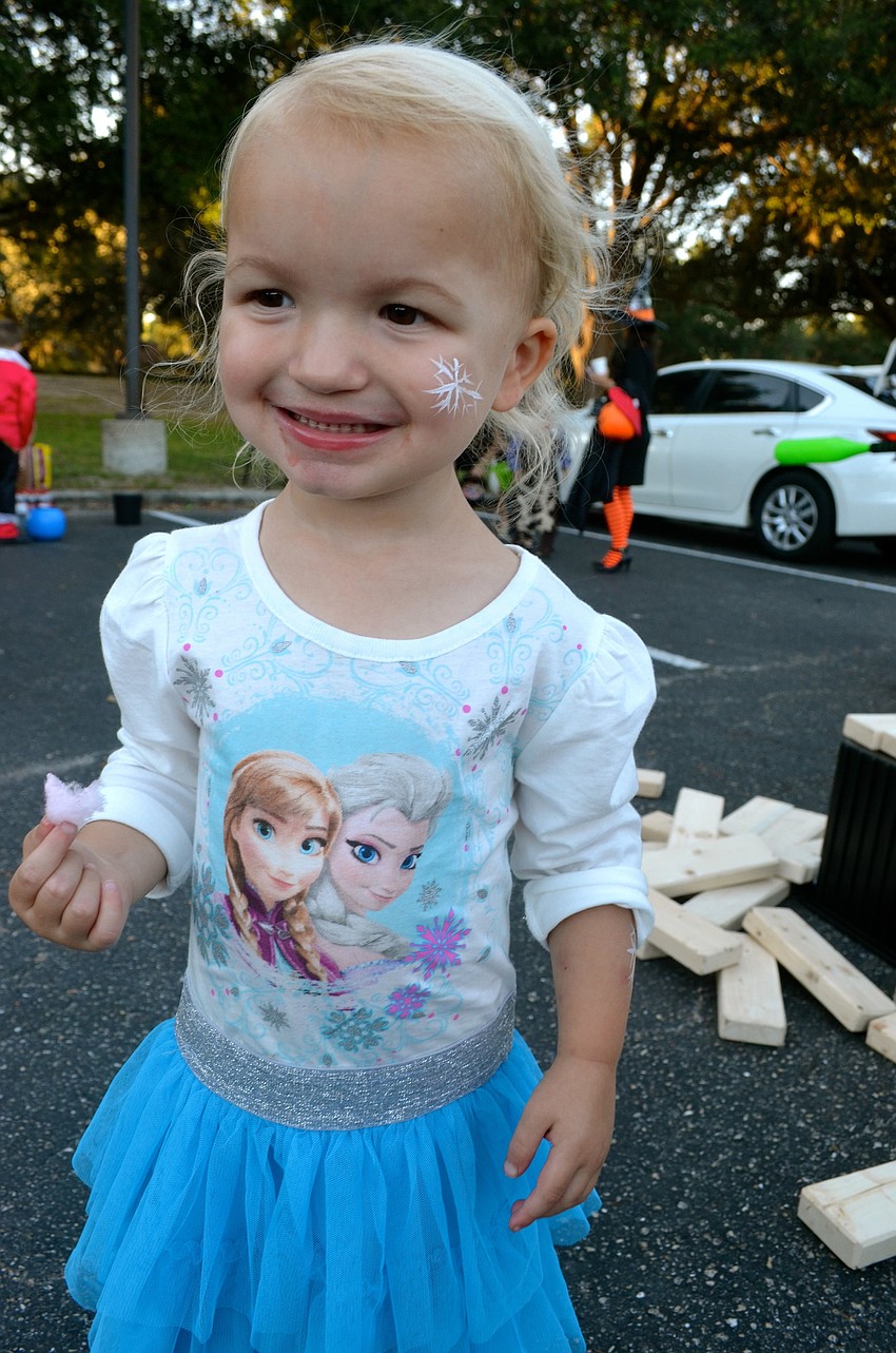 Emily Mallek smiles with a mouth full of cotton candy.