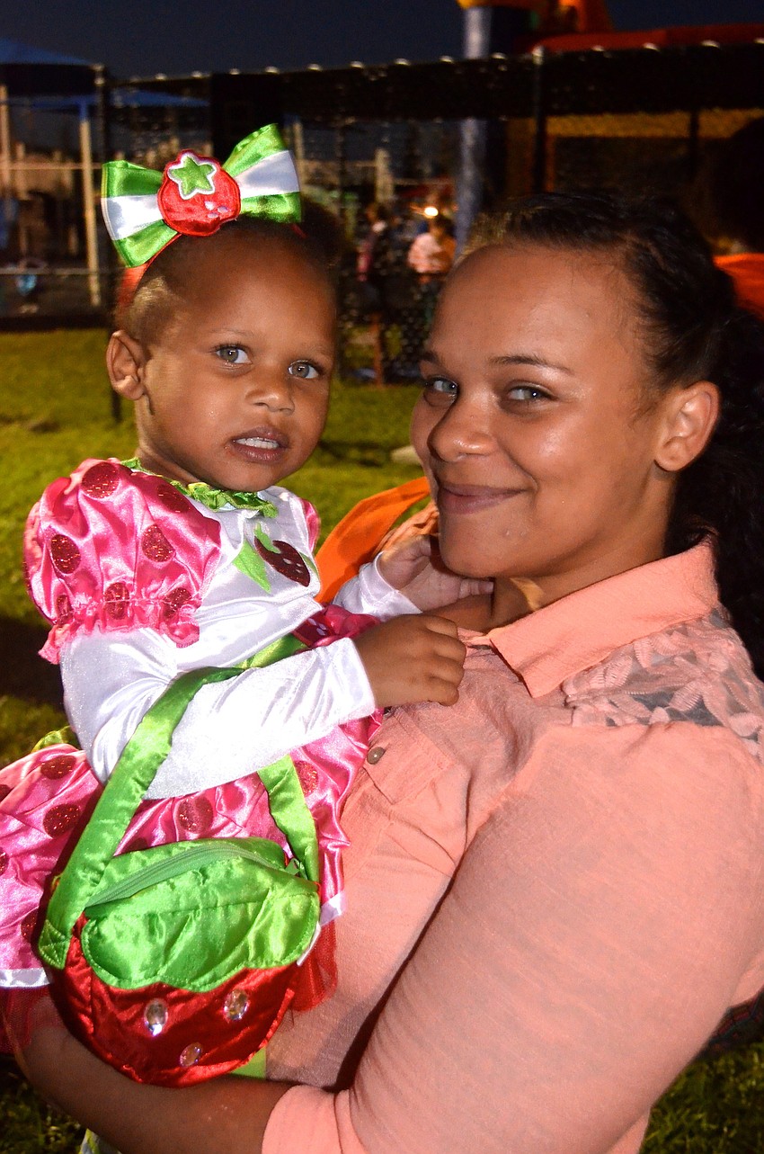 Ezaisha Johnson sports a strawberry-themed outfit beside her mother, Desirea.