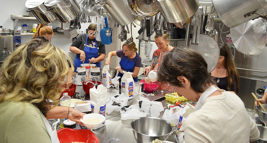 Women of the Temple Emanu-El congregation gathered to learn Rabbi Glickmanâ€™s challah bread recipe.