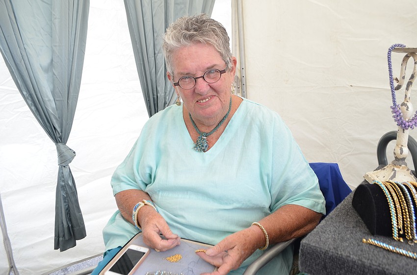 Jeweler Loretta Fehling begins creating a bracelet.