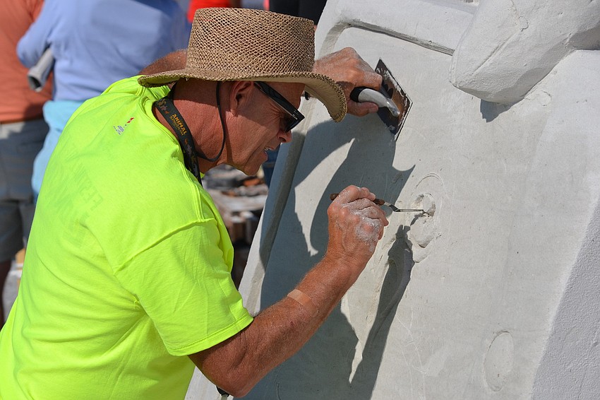 Ron MacDonald works on a selfie for the â€œSiesta Selfieâ€ sculpture.